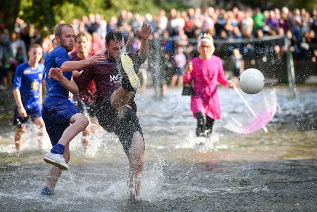 Players from teams of Bourton Rovers fight for possession of the ball