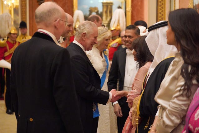 The King and Queen greeting guests