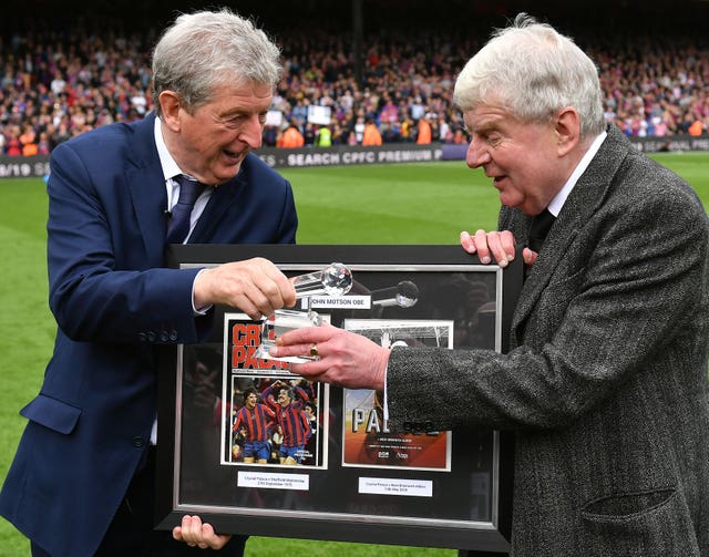 Motson (right) is handed a gift by Crystal Palace manager Roy Hodgson