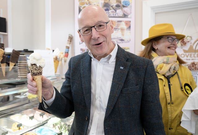 John Swinney smiling while holding an ice cream in his right hand