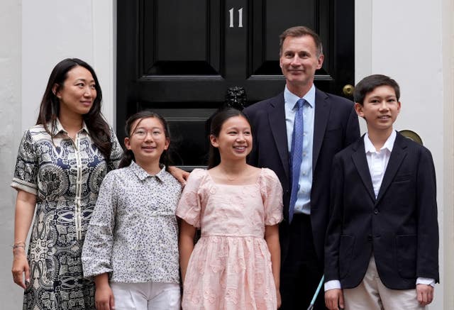 Jeremy Hunt with his wife, two daughters and son in front of the black door of Number 11 Downing Street