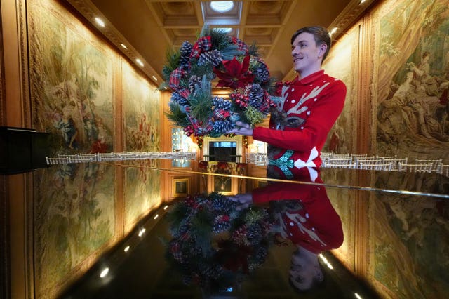 Man holds a Christmas wreath