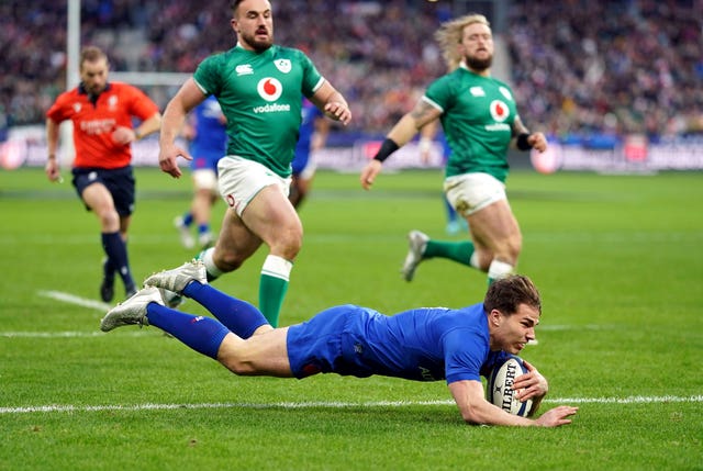 France’s Antoine Dupont dives in to score the opening try