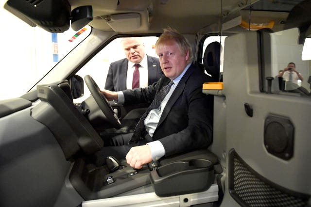 Boris Johnson sits in a taxi