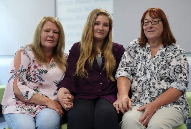 Katie Pitwell, centre, the daughter of acid attack victim Joanne Rand with Joanne’s sisters Lynn Ryan, left, and Jacqueline Joiner (Yui Mok/PA)