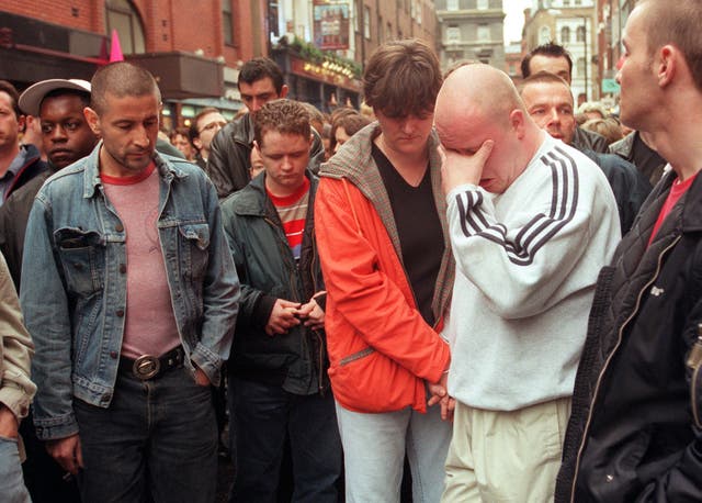Friends and relatives of the victims of the Soho bomb blast attend a Vigil of Remembrance, at the scene outside the Admiral Duncan pub in 1999.