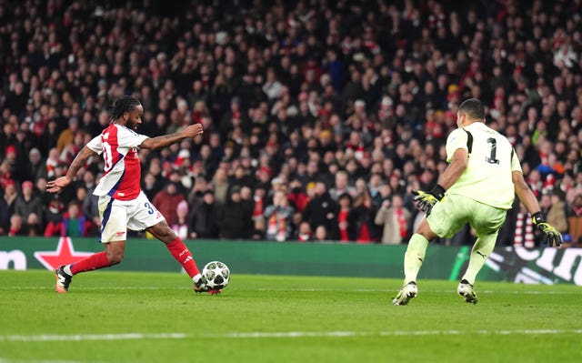 Raheem Sterling attempts to lift the ball over the goalkeeper with his left foot