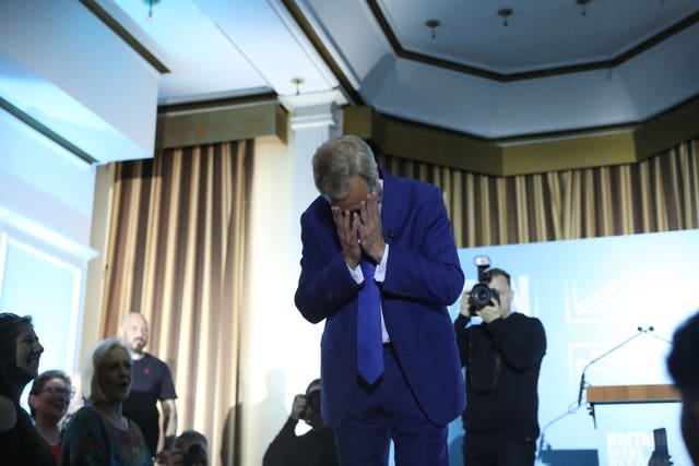 Reform UK leader Nigel Farage holds his head in his hands after speaking at an event at the Imperial Hotel in Blackpool