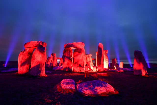 Stonehenge in Wiltshire is lit up by Finnish light artist Kari Kola to mark Unesco World Heritage Day and to mark 100 years of care and conservation (Ben Birchall/PA)
