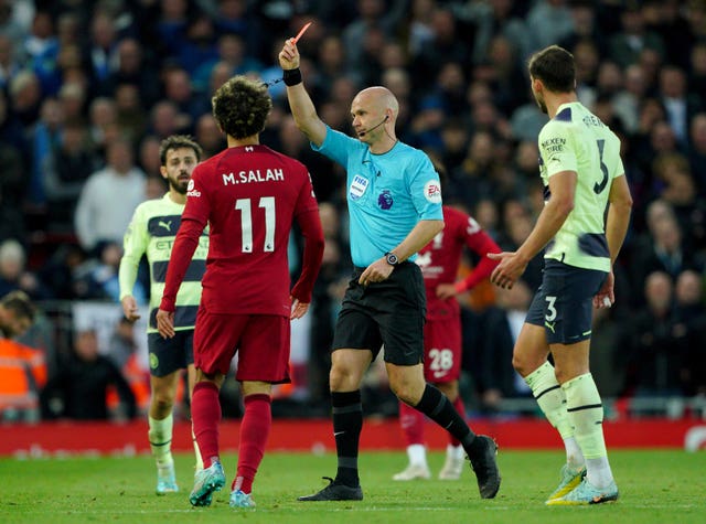 Referee Anthony Taylor shows Klopp a red card