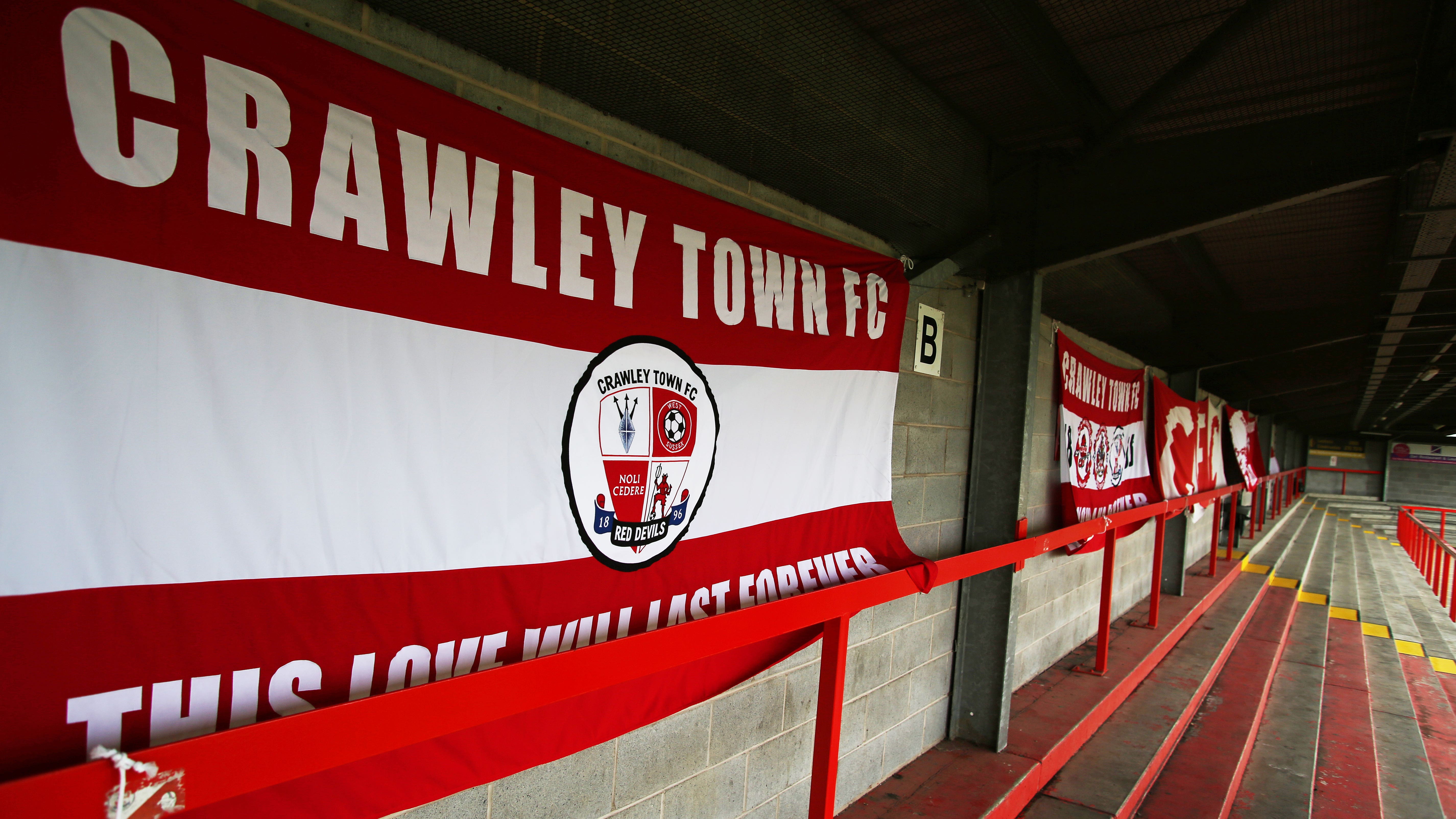 A general view of Crawley Town flags attached to an empty terrace inside the ground before the Sky Bet League Two match at The People’s Pension Stadium, Crawley.