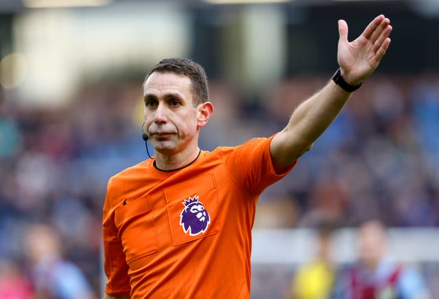 Former Premier League referee David Coote gives a signal during a match