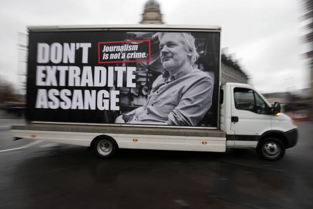 A van with an advert supporting Julian Assange circles Parliament Square in Westminster, London  (Jonathan Brady/PA)