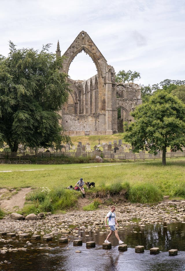 People enjoy the hot weather at Bolton Abbey in North Yorkshire