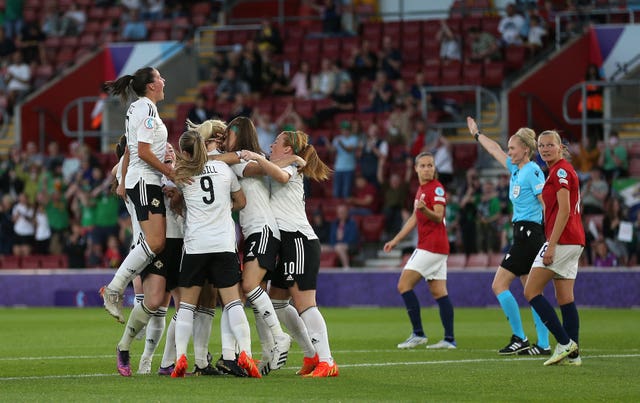 Northern Ireland’s Julie Nelson is mobbed by team-mates after scoring