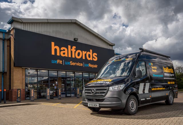 A Halfords van parked outside a Halfords store 