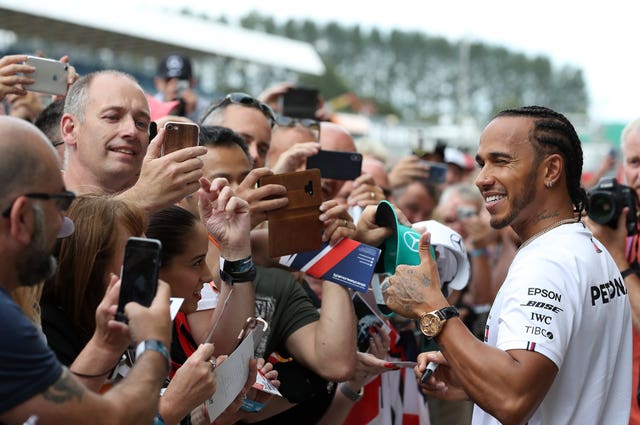 Lewis Hamilton gives a thumbs up to the crowd at Silverstone