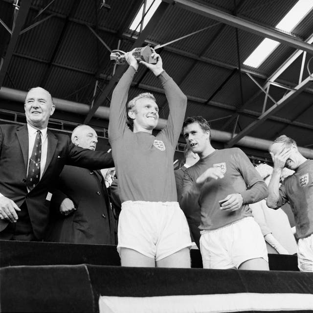 Charlton (far right) appears overcome with emotion as England captain Bobby Moore (centre) lifts the Jules Rimet trophy at Wembley following the defeat of West Germany. Between Moore and Charlton is Hurst (PA).