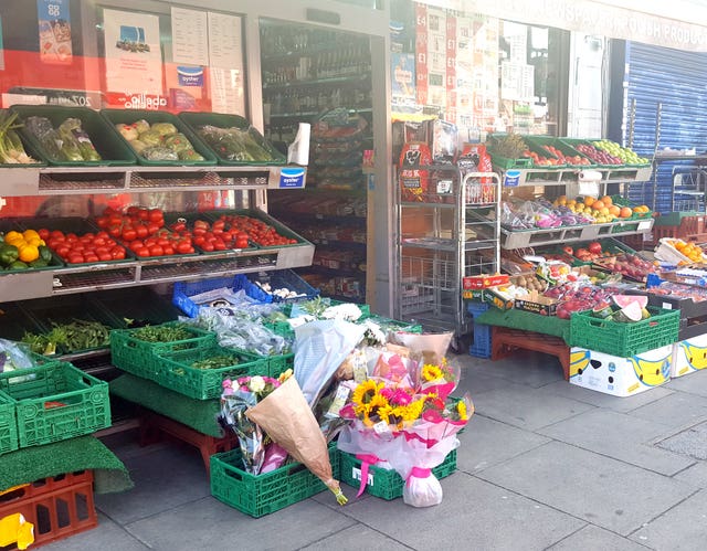 Flowers and a message outside a shop in Uxbridge Road 