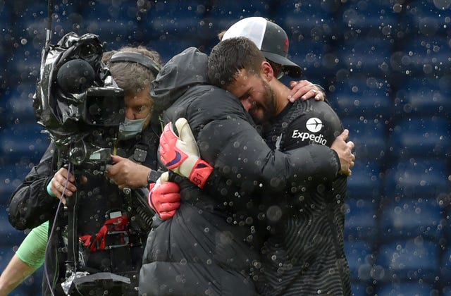 Liverpool goalkeeper Alisson embraces manager Jurgen Klopp 
