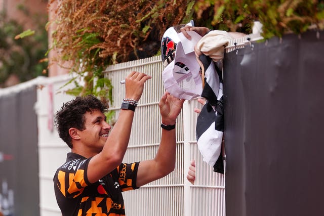 Lando Norris signs autographs for fans 