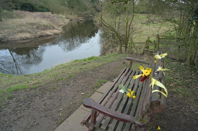 Flowers, and ribbons are tied to a bench by the River Wyre in St Michael’s on Wyre