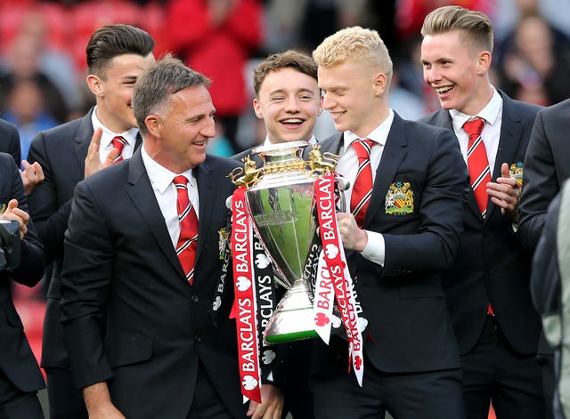 Manchester United Under-21s captain James Weir holds the U21 Premier League trophy at Old Trafford in 2016