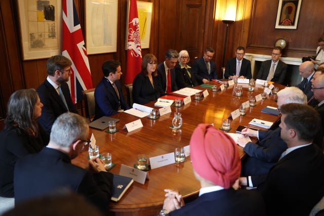 Rachel Reeves and Ed Miliband sitting around a table with petrol bosses