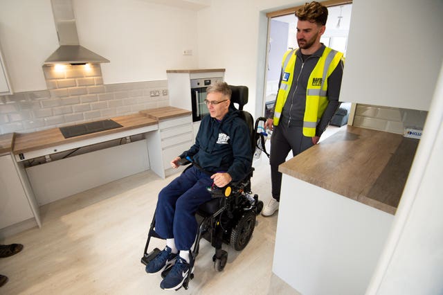 Rob Lamb is shown around the modified kitchen