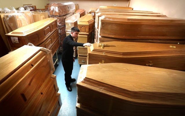 Declan Harley from Anderson Maguire Funeral Directors checks the empty coffins in the storage room at their offices in Glasgow (Andrew Milligan/PA)