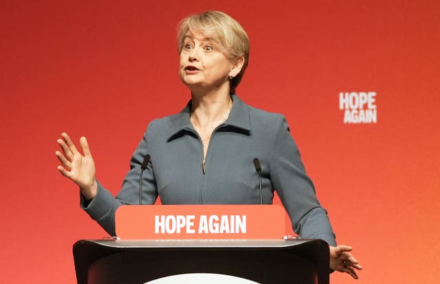 Yvette Cooper speaking from behind a podium bearing the words 'hope again'