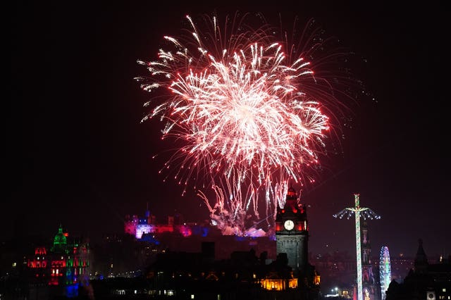 Fireworks explode over Edinburgh Castle and the Balmoral Clock