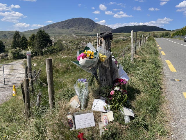 Flowers and tributes left at the entrance to a farm