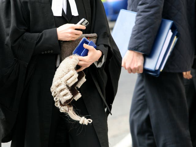A barrister carries a wig 