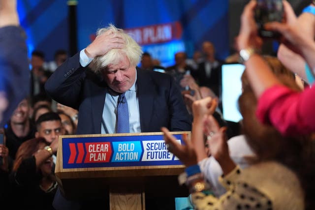 Boris Johnson running his hand through his hair while giving a speech at a Conservative Party rally on Tuesday night 