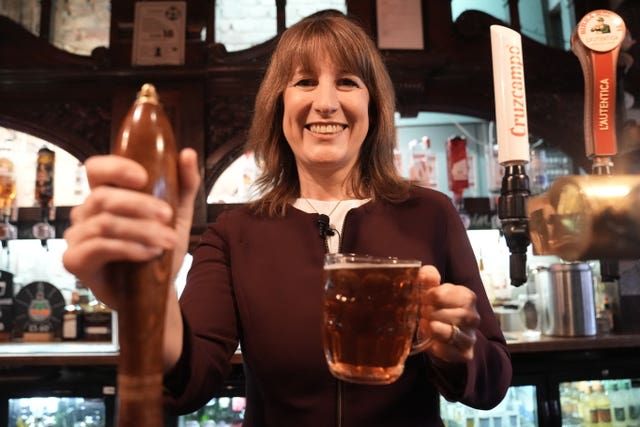 Chancellor Rachel Reeves serves a pint in a pub