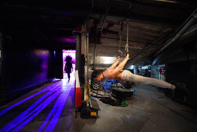 Indira Avila walks past Glenn Folco after going through her routine at Blackpool Tower Circus
