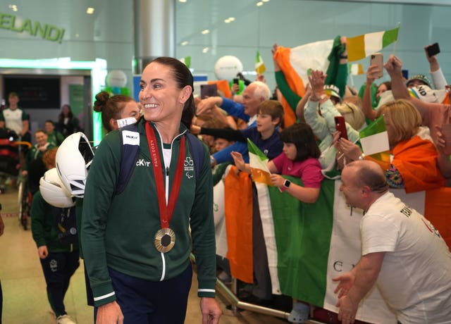 Fans wave and cheer as they greet Ireland’s Eve McCrystal at Dublin Airport