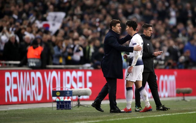 Son Heung-min, left, embraces manager Mauricio Pochettino