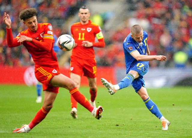 Oleksandr Zinchenko, right, goes for goal