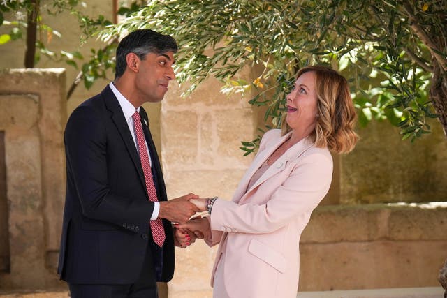 Rishi Sunak is welcomed to the G7 summit by Italian prime minister Giorgia Meloni as they both smile at each other