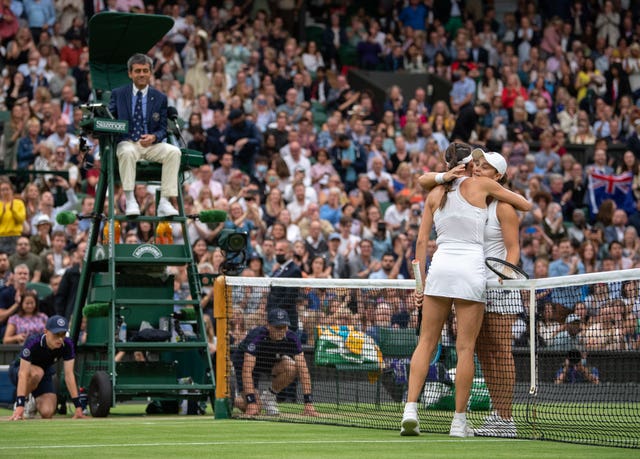 Ashleigh Barty (right) hugs Ajla Tomljanovic on Centre Court 
