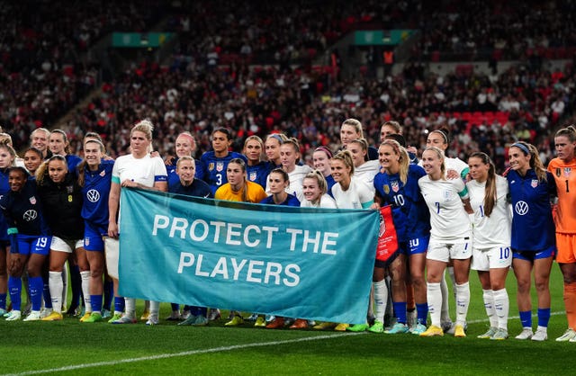 England and the United States display a banner that reads ''Protect the players''