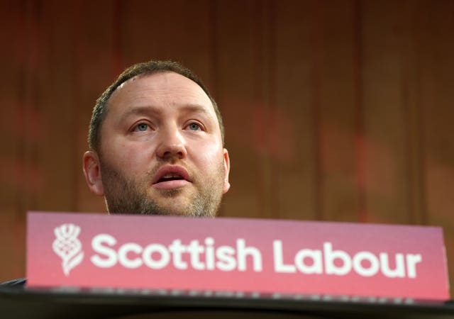 Ian Murray behind a Scottish Labour podium