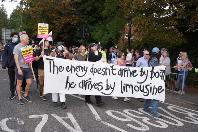 People take part in a Stand Up To Racism rally outside the Four Points By Sheraton hotel in Horley, Surrey