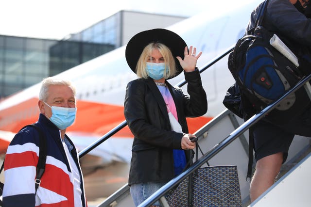 Passengers prepare to board an easyJet flight to Faro, Portugal, at Gatwick Airport