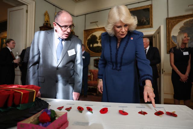 Queen Camilla views an exhibition of poppies and wreaths showing the evolution of the poppy as a symbol of remembrance 