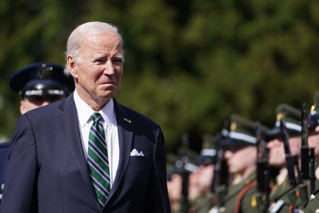 US President Joe Biden inspects the guard of honour during his visit to Aras an Uachtarain, in Phoenix Park, Dublin, on day three of his visit to the island of Ireland