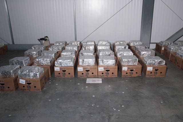 Crates of bananas with foil packages on top