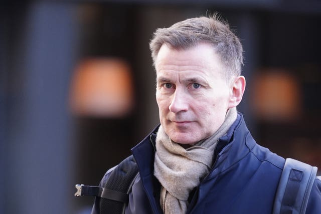 Head and shoulders photo of Jeremy Hunt wearing jacket, scarf and rucksack